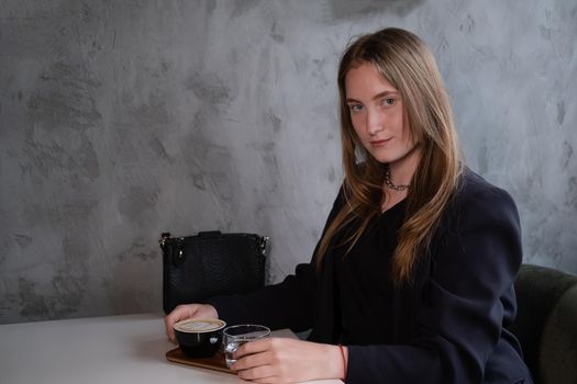 charming confident brunette woman in a cafe with coffee. coffee break. business woman.