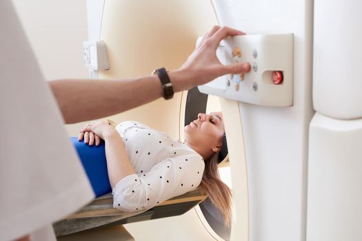 Female patient undergoing MRI - Magnetic resonance imaging in a Hospital. Medical Equipment and Health Care