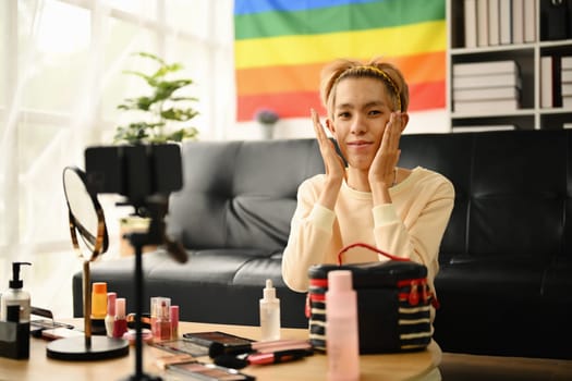 Young queer man beauty make up artist or vlogger recording makeup tutorial in home studio. LGBTQ lifestyle, influencer, blogger.