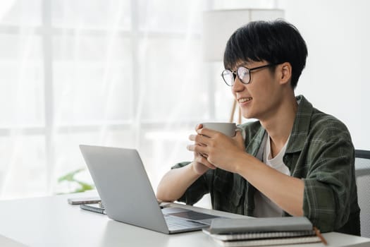 Young student busy study make notes in notebook and using laptop concentrated online training course technology education..