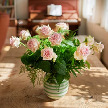 Closeup of bouquet of pink roses in a vase, flowers and nature on living room table, gift for romance or friendship. Plant, botanical and symbol of love, natural and floral arrangement at home.