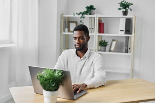 modern man laptop student distance indoor business desk chat freelancer american education sitting blank technology computer office space home online job african african
