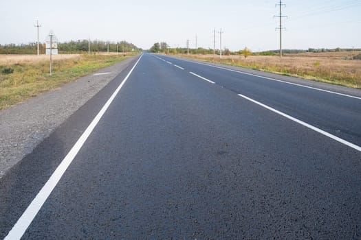 Asphalt highway road. Asphalt road and white dividing lines. download photo