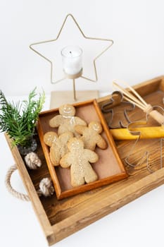 Gingerbread Man. Cooking gingerbread at home lies on a wooden tray. Holiday concept