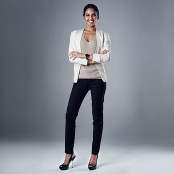 Business presence that makes a distinctive impression. Studio portrait of a young businesswoman posing against a gray background