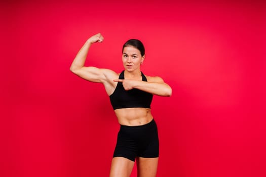 Woman Boxer In Gloves Training On a black, red, yellow Background