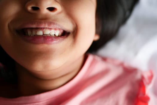 child smiling with healthy white teeth