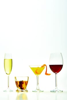 set with different drinks on white background - champagne, whiskey, cocktail, wine