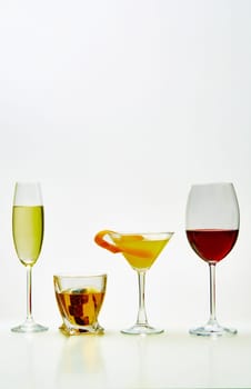 set with different drinks on white background - champagne, whiskey, cocktail, wine