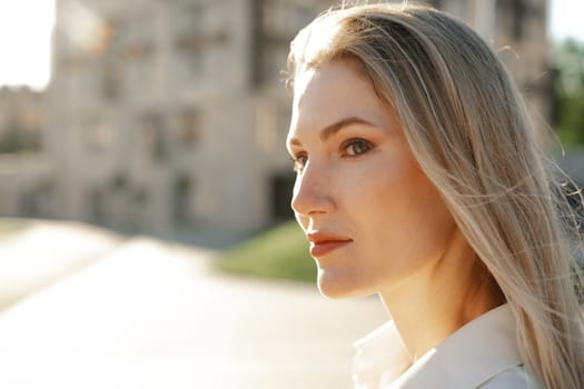 Close up portrait of young blonde businesswoman outdoors