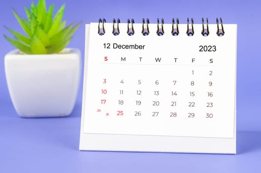 December 2023 Monthly desk calendar for 2023 year on purple background.