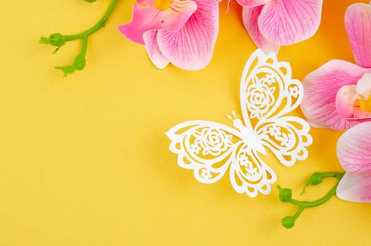 Butterfly Paper Cut with pink color orchid on yellow background