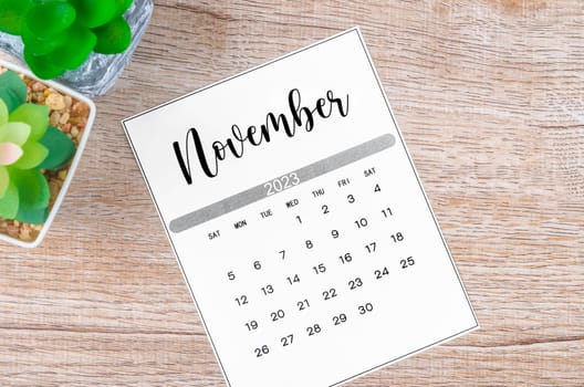 November 2023 Monthly calendar for 2023 year on wooden background.