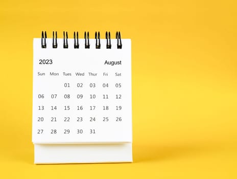 August 2023 desk calendar on yellow color background.