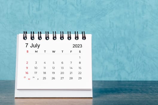 July 2023 desk calendar on blue color background, Vintage style.