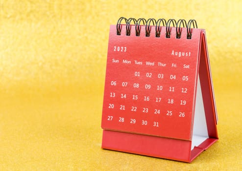 Red August 2023 Monthly desk calendar for 2023 year on golden color background.