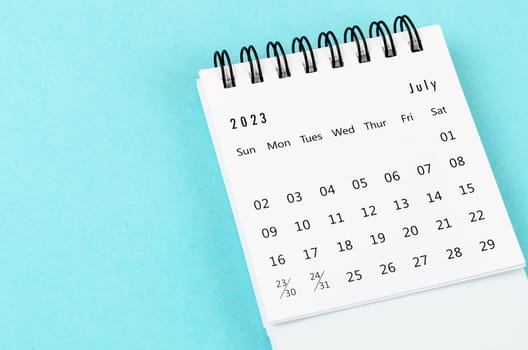 July 2023 Monthly desk calendar for 2023 year on blue background.