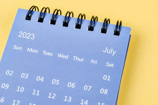 July 2023 Monthly desk calendar for 2023 year on yellow background.