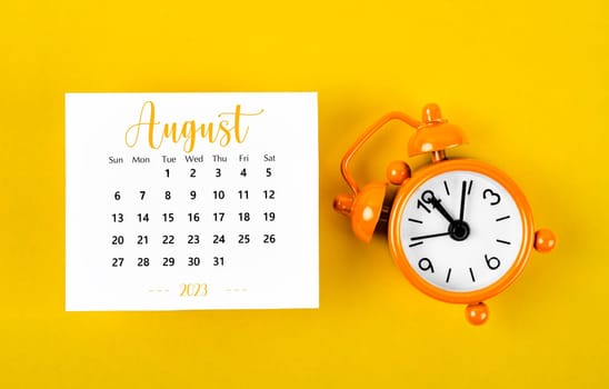 August 2023 Monthly calendar for 2023 year with black colour alarm clock on yellow background.