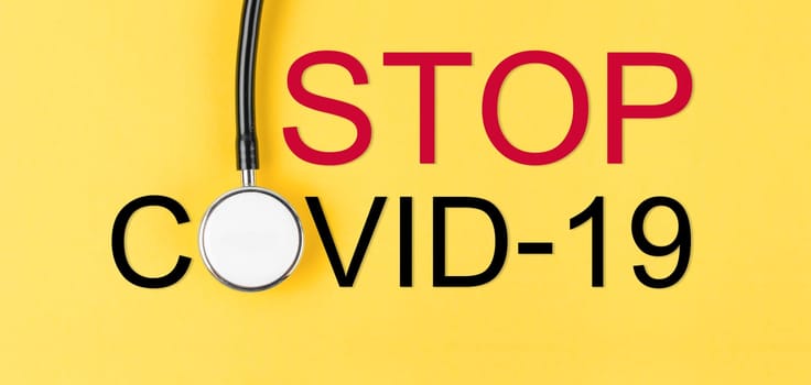 Stop coronavirus. Coronavirus (COVID-19) outbreak is giving rise and stethoscope medical on yellow background.
