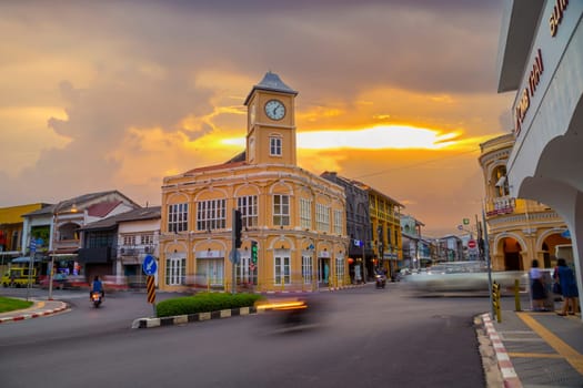 Phuket Thailand , September 14th 2020 ; Landmark chino-portuguese clock tower in phuket old town, Thailand, with light trails on road in twilight time.