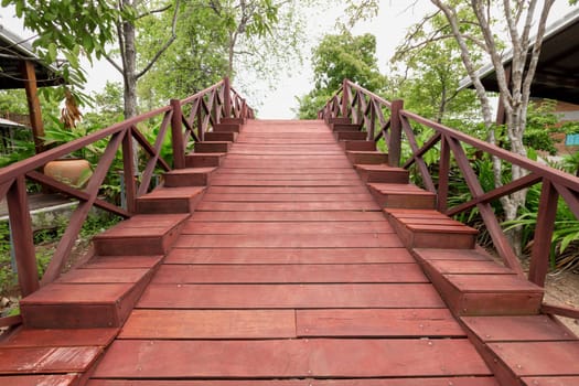 Old red wooden bridge in the countryside.