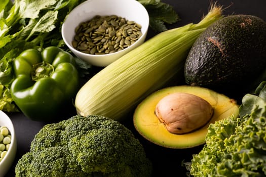 High angle view of various green fruit, vegetables and seeds on table. unaltered, healthy food, vegetable, raw food, variation and organic concept.