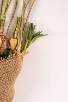 Overhead view of fresh organic vegetables with burlap on white background, copy space. unaltered, food, healthy eating, organic.