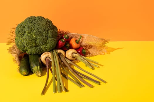 High angle view of various fresh organic vegetables with burlap on dual toned background, copy space. unaltered, food, organic, studio shot, healthy eating.