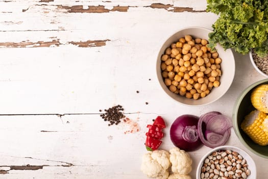 Overhead view of various healthy food and ingredients on white table, copy space. unaltered, food, preparation, healthy eating.