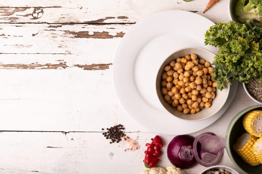 Directly above shot of healthy food and ingredients on white table, copy space. unaltered, food, preparation, healthy eating.