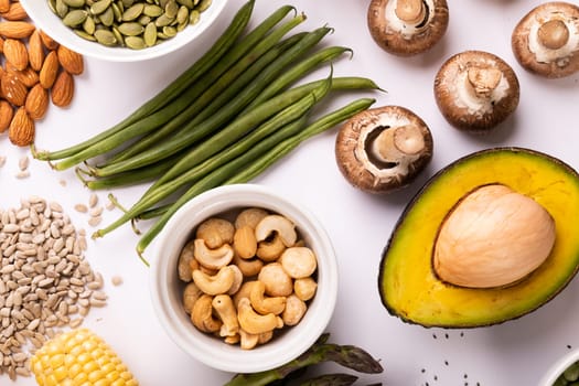 High angle view of healthy food and ingredients arranged on white table, copy space. unaltered, food, preparation, healthy eating.