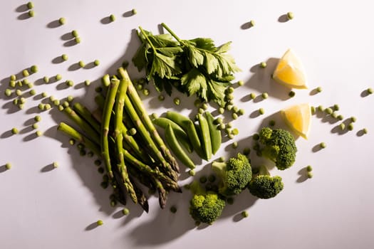 Directly above view of fresh green vegetables on white background. unaltered, food, healthy eating, organic concept.