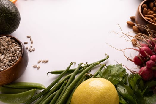 Directly above view of copy space by various fresh vegetables and fruits on white background. unaltered, food, healthy eating, organic concept.