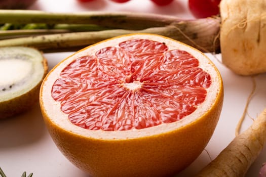 Close-up of fresh grapefruit halved amidst various food on table. unaltered, food, healthy eating, organic concept.