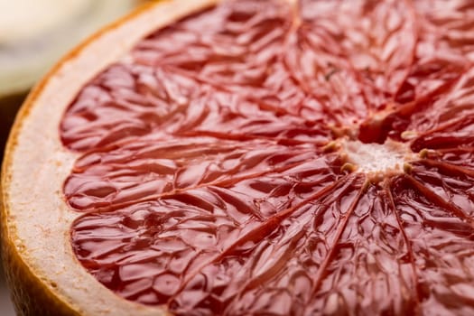 Close-up view of fresh textured grapefruit halved cross section. unaltered, food, healthy eating, organic concept.