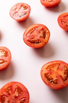 High angle view of fresh tomato halves on white background. unaltered, food, healthy eating, organic concept.