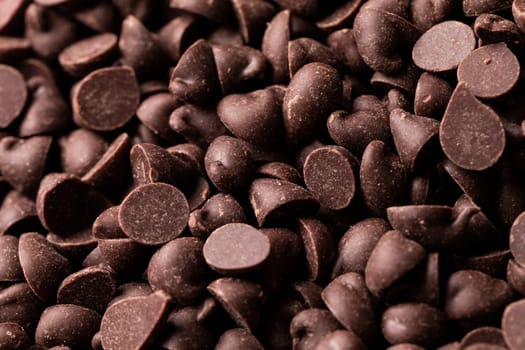 Full frame close-up view of fresh brown chocolate chips. unaltered, sweet food and unhealthy eating concept.