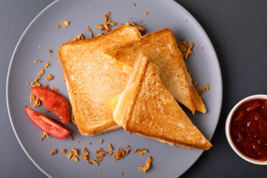 Overhead view of fresh cheese toast sandwich with tomato slices and dip. unaltered, food, unhealthy eating and snack concept.