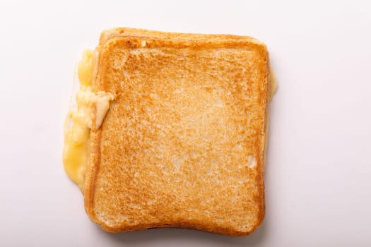 Directly above view of fresh cheese toast sandwich over white background. unaltered, food, unhealthy eating and snack concept.