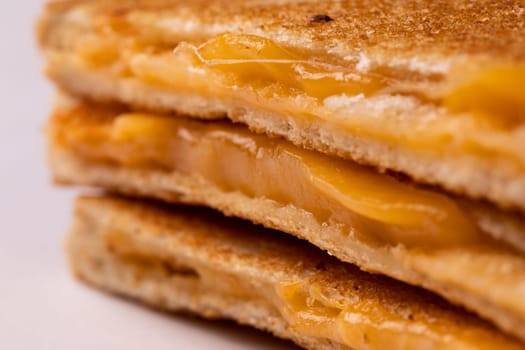 Close-up of fresh melting cheese in toast sandwich. unaltered, food, unhealthy eating and snack concept.