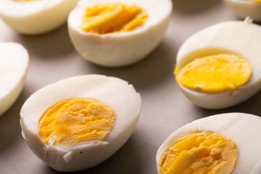 High angle view of fresh white boiled eggs with yellow yolks on table. unaltered, food, healthy eating and organic concept.