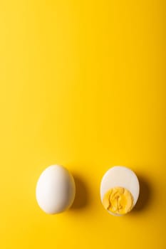 Directly above view of fresh white boiled eggs with copy space on yellow background. unaltered, food, healthy eating and organic concept.