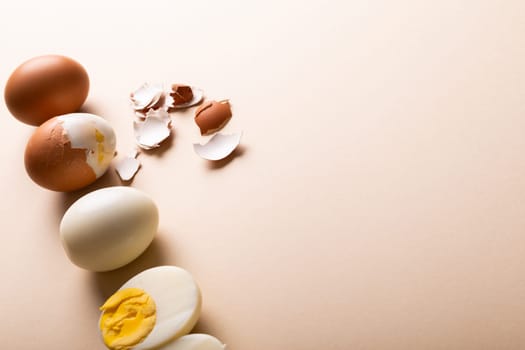 High angle view of fresh brown and white boiled eggs by copy space on pink background. unaltered, food, healthy eating and organic concept.