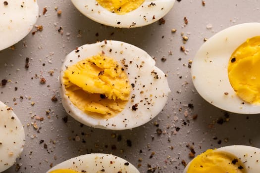 Overhead close-up view of fresh boiled white eggs with peppercorn seasoning. unaltered, food, healthy eating and organic concept.