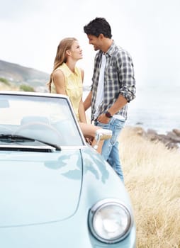 Youre the one for me. A young couple sharing a romantic moment on a hilltop after taking a scenic drive