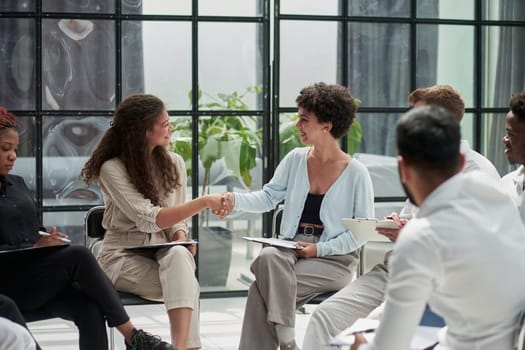 Manager greeting new employee and smiling in office