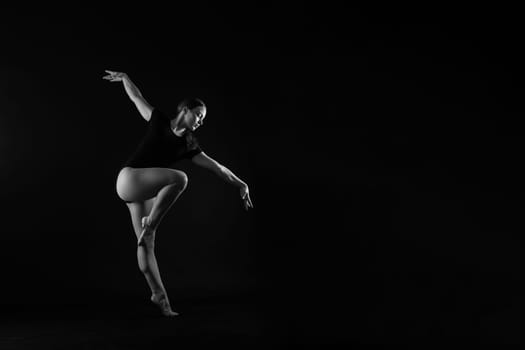 Sportive exercises, standing and stretching the hands. Beautiful muscular woman in indoors studio.