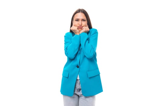 young emotional brunette secretary woman in blue jacket worries worries on white background with copy space.