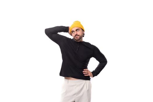 young brutal caucasian brunette man with beard in casual sweatshirt isolated on white background with copy space.